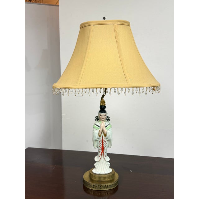Design Plus Gallery presents a Vintage Chinoiserie Porcelain Figural Table Lamp. The lamp showcases a hand-painted...