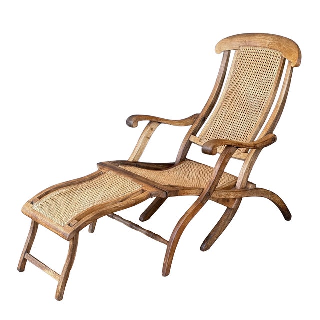A fine French cruise liner or steamer deck chair (also known as a chaise longue) of patinated teak-wood and woven cane,...