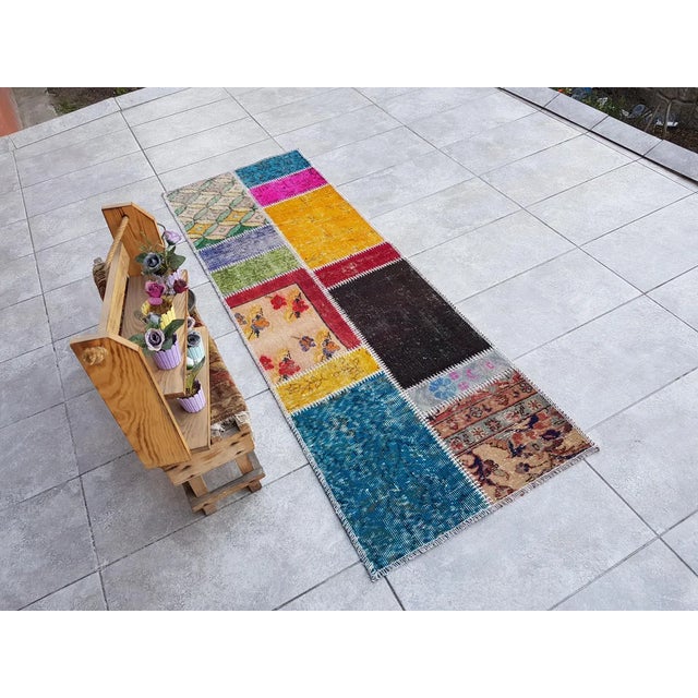 This is a vintage Turkish Oushak rug from the Mid 20th Century. The piece was hand-knotted.