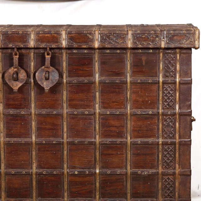 Antique Indian Teakwood and Brass Pitara Chest Console, a 19th c. chest reduced in depth to make a stunning console. The...