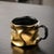Using ceramic gold plating (or a metallic coating), the cup body features an irregular, pleated shape, breaking away from...