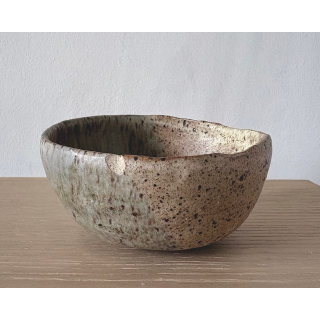 An organically formed American studio pottery bowl made in New York, with an intentionally irregular rim and a nuanced,...