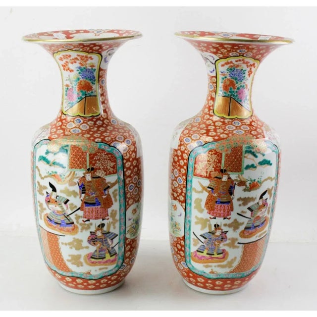 Beautiful pair of Late 19th Century Japanese porcelain vases showcasing a mesmerizing blend of artistic depictions and...