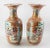 Beautiful pair of Late 19th Century Japanese porcelain vases showcasing a mesmerizing blend of artistic depictions and...