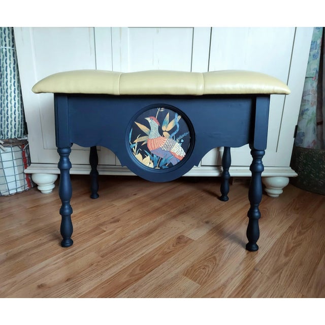 This one of a kind leather topped bench/stool with biscuit buttoned detail features vintage art nouveau fabric placed in a...