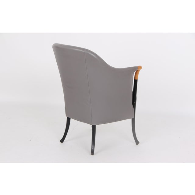 Six beautiful Italian furniture classics in light and black lacquered wood, upholstered in grey leather. The armchairs are...