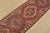 A tribal Caucasian Kazak runner hand-knotted with fine wool on a cotton foundation. This rug features geometric medallions...