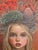 The artwork features a young girl adorned with a striking crown of poppies and natural elements, creating a harmonious...