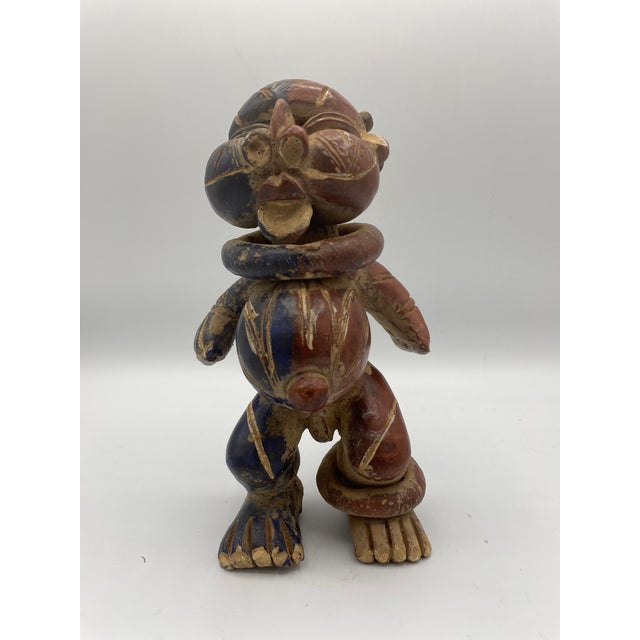Terracotta figure of a Pygmy spirit believed to once inhabit the grasslands of Cameroon. Charming polychrome detail and...