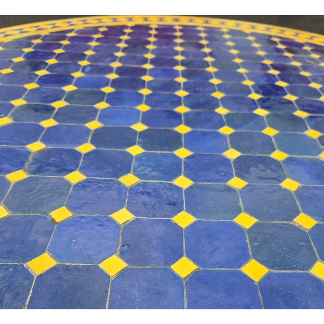 Beautiful handcrafted Moroccan mosaic table featuring an elegant blue and yellow color palette. Measuring 40 inches in...
