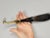 A Chinese calligraphy brush with a small antler handle having a bit of hair remaining at the ferrule. Ferrule is made of...