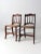 This is a pair of antique wooden side chairs. The wood chairs feature elegant bannister backs with decoratively shaped...