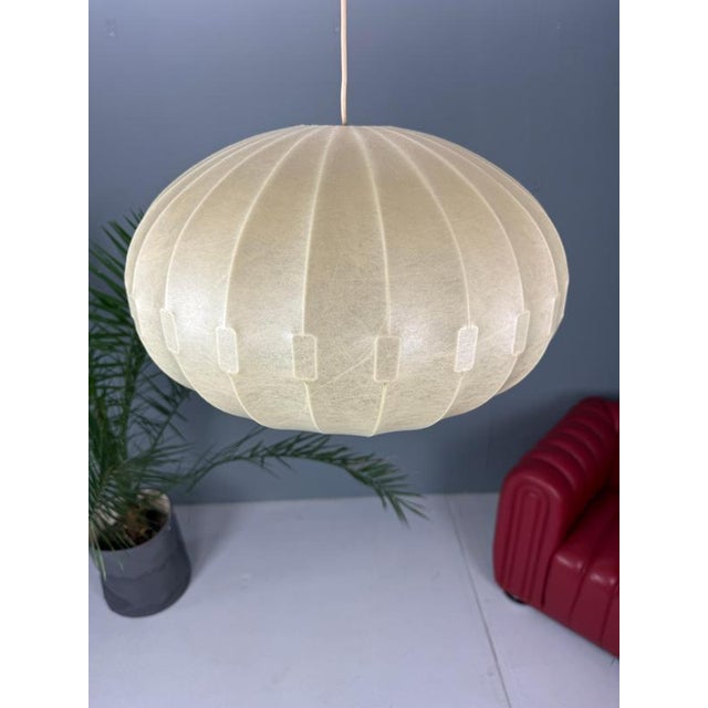 First of all, this lamp is in a very good condition! This sculptural pendant lamp was designed by Friedel Wauer for...