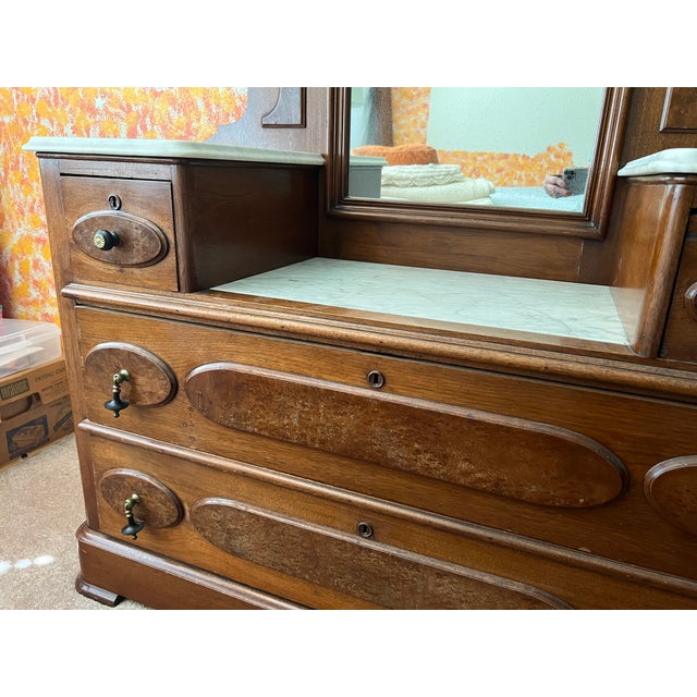 This is a beautiful, original, Renaissance Revival marble top Dresser. It has a drop center with the original marble tops....