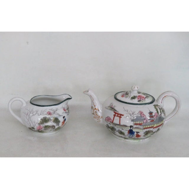 This lovely tea pot and creamer set is made of porcelain. This set has a wonderful Nippon style, it is stamped as having...