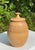 Striking vintage handcrafted studio pottery vessel with a rounded, organic form and fitted lid topped by a sculptural...
