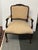 Design Plus Gallery presents an Ornate Carved Wood Armchair. The shaped wood frame displays elaborate carved detailing...
