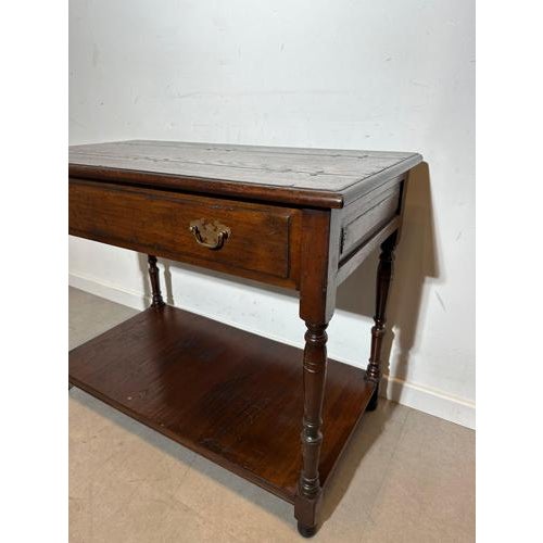 Charming old English side table crafted in solid oak, reflecting the warm and timeless character often associated with New...