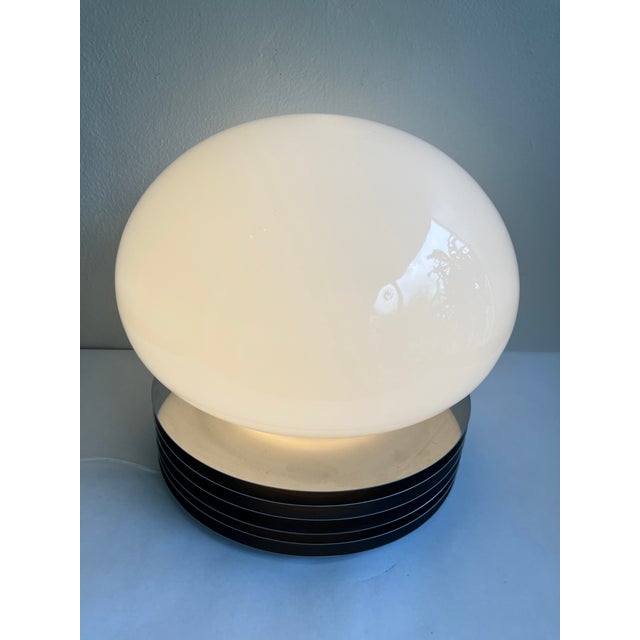 This is a wonderful Machine-Age style table lamp designed by Enrico Tronconi , circa 1960s. The lamp features a blown...