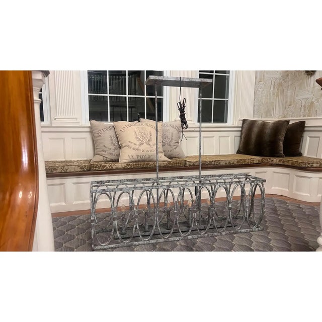 Distressed painted steel chandelier featuring 6 candelabra bulbs. This was a floor sample and in like new condition.