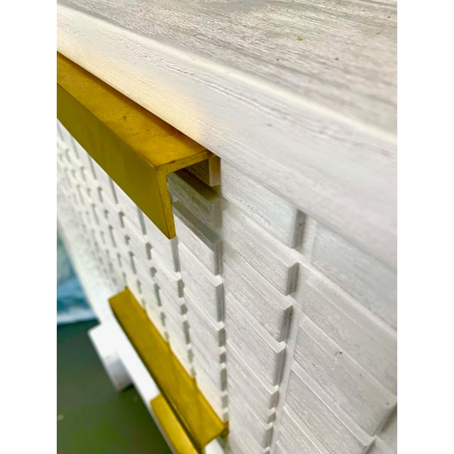 Handsome textured/grooved geometric pattern on doors in painted mahogany. Brass detail on pulls adds modern detail. This...