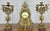 This striking Vintage French mantel clock garniture features an architectural openwork brass design, paired with a...