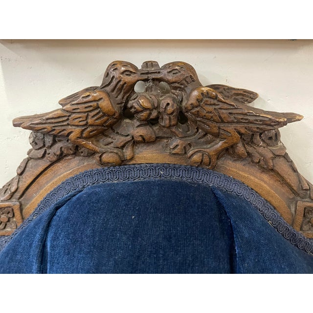 Features deep button tufted blue velvet upholstery and an elaborately carved wood frame. Scalloped silhouette with...