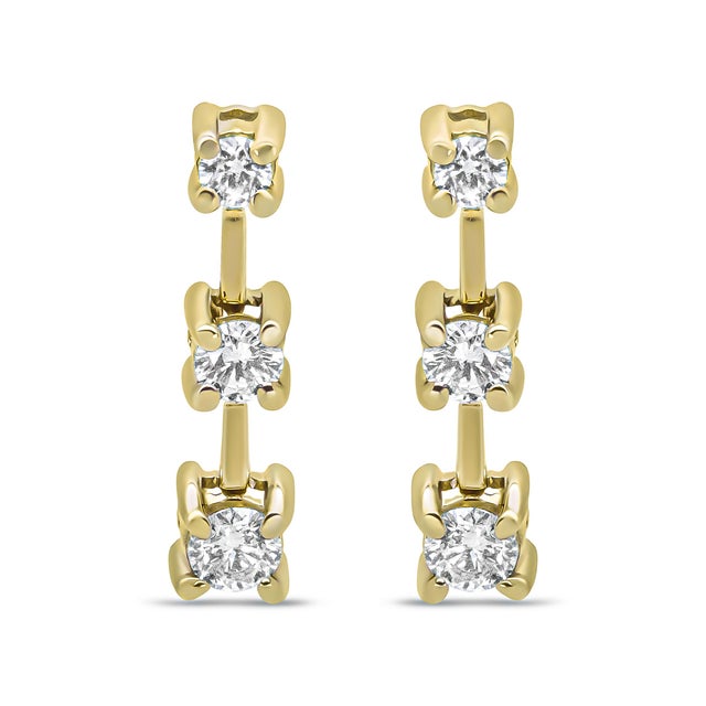 This fabulous three stone diamond earrings are set in a graduating design that align with the smallest stone at the top...