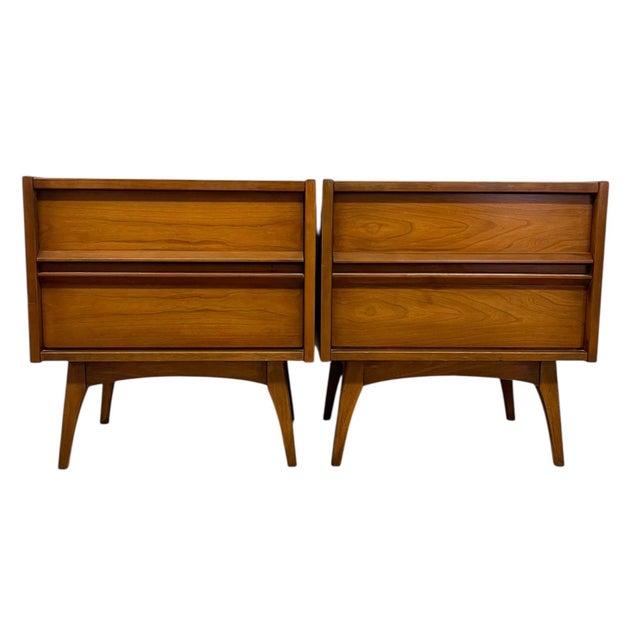 This matching pair of vintage mid century modern nightstands features clean,architectural lines and a warm wood tone...