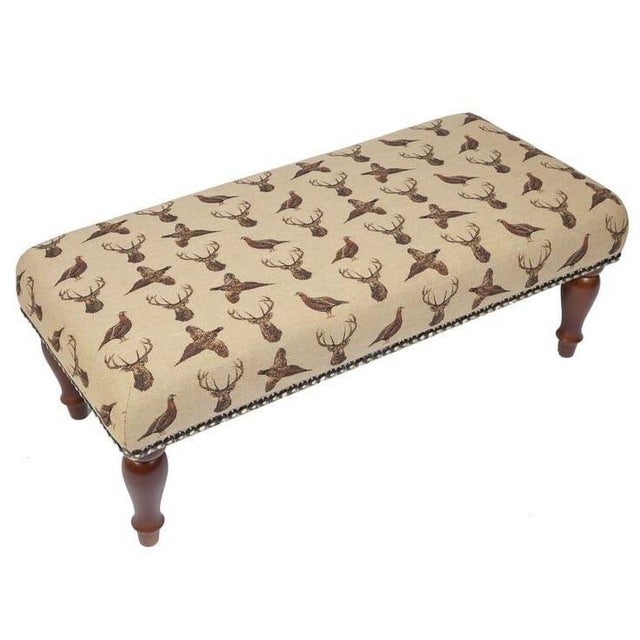 Meticulously handcrafted in the United Kingdom, this upholstered stool boasts classic studding and hand-polished solid...