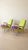 A distinctive pair of vintage armchairs from Czechoslovakia, featuring angled wooden frames, tapered legs, and gently...