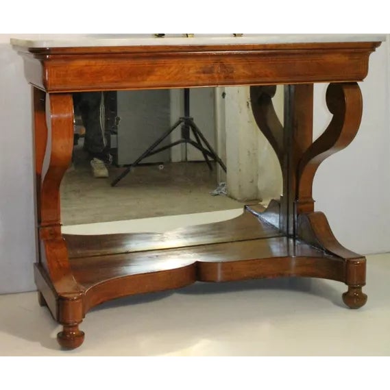 Charming Regency style hallway console entry table made of mahogany featuring a large rectangular white marble top with...