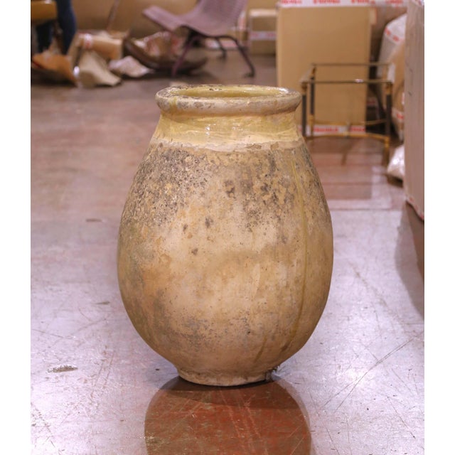 This large antique olive oil jar was crafted in Biot, Provence, circa 1780. Made from blond clay and shaped in the...