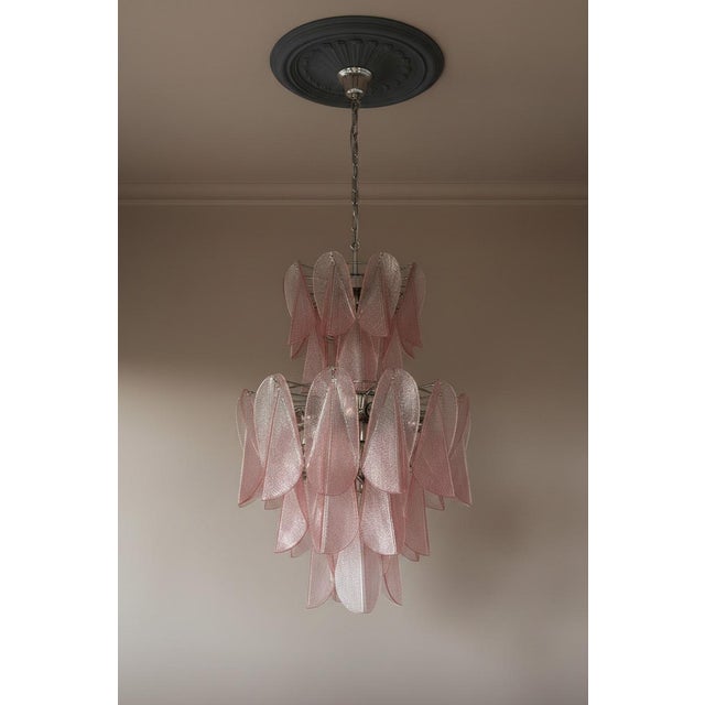 DUTIES FREE A striking contemporary chandelier handcrafted in Murano, Italy, featuring an elegant composition of hand-...