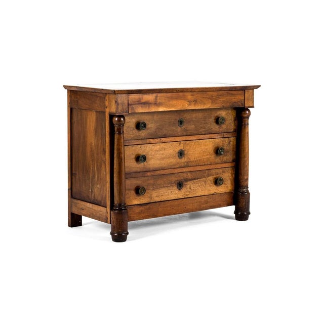 A charming walnut chest of drawers or commode of small stature yet elegantly refined. The chest has an arrangement of...