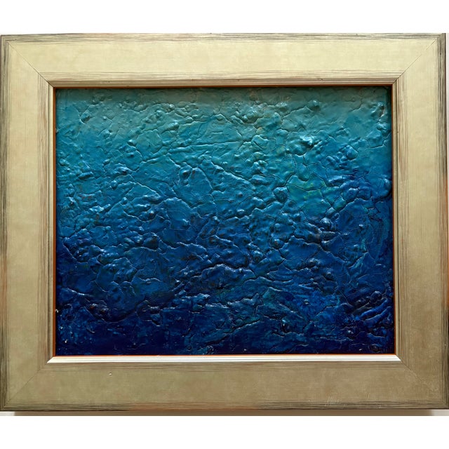 An ombré ocean blue textured oil painting. A heavily textured blue abstract painting, with a thick, sculpted surface...