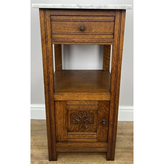 A beautiful Antique French single bedside table, crafted in oak and complemented by an elegant marble top. Featuring one...