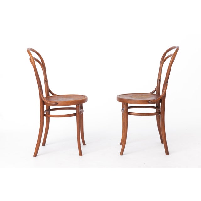 A charming pair of antique bentwood chairs dating from approximately the 1930s–1950s. The manufacturer is unknown, but the...