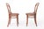 A charming pair of antique bentwood chairs dating from approximately the 1930s–1950s. The manufacturer is unknown, but the...