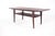 Elegant rectangular rosewood coffee table. with a shelf supported by four metal supports. Denmark, 1960s. This piece is...
