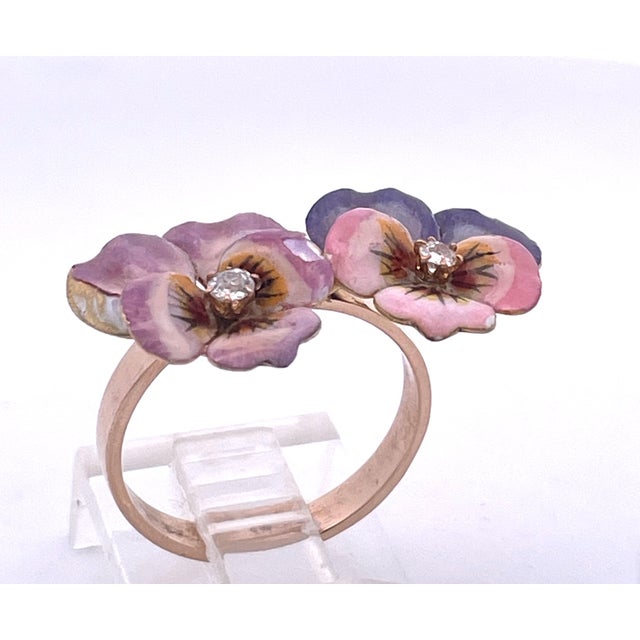 This enchanting antique brooch features a double pansy design, masterfully executed in polychrome enamel on a 14K yellow...