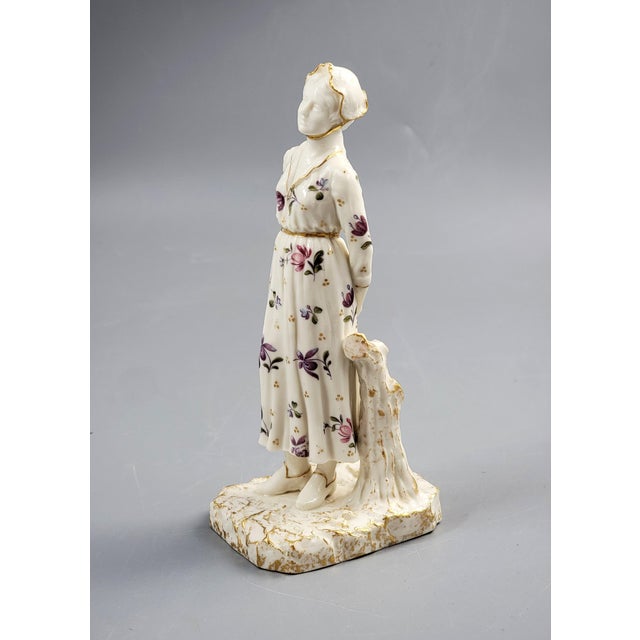 An elegant Royal Worcester porcelain figure of a bonneted woman, produced circa 1920. The model exemplifies the factory’s...