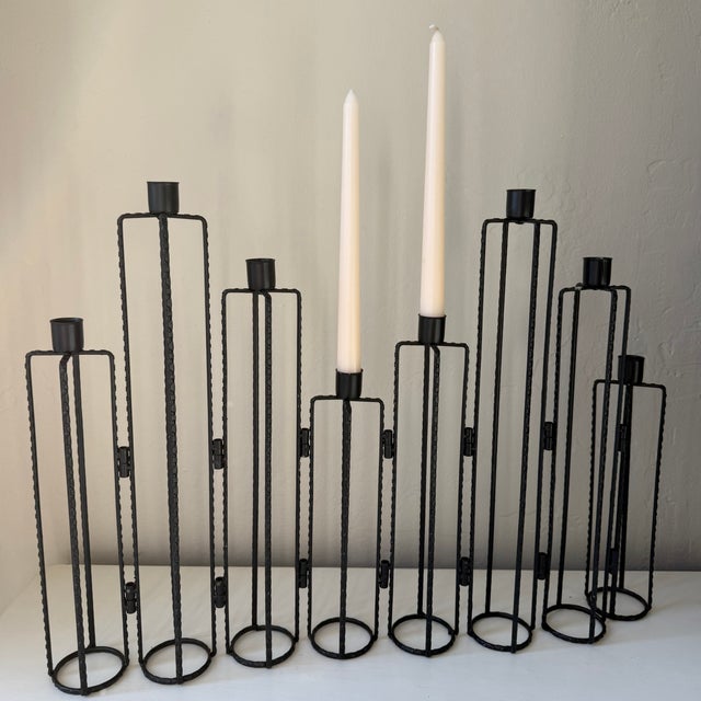 Black Brutalist style expandable sculptural multi-holder tapered candelabra in a stepped silhouette. Each metal leg has a...