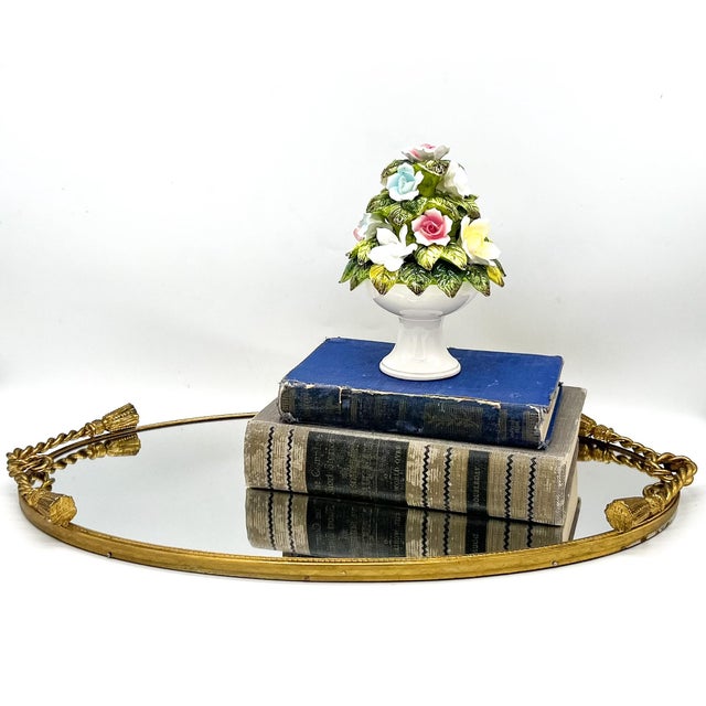 Elegant vintage oval mirrored vanity tray featuring a beautifully detailed gilt metal frame with twisted rope sides and...