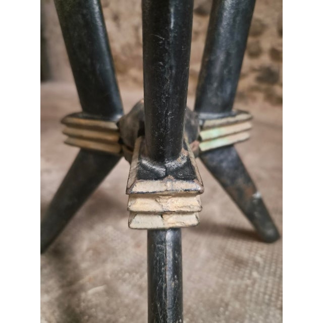 This French bistro table dates from the Art Deco period, circa 1930–1940. It features a painted iron tripod base and...