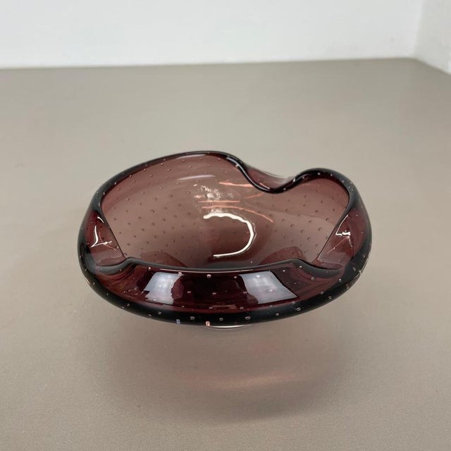 Article: Murano glass bowl, ashtray element Origin: Murano, Italy Decade: 1970s This original glass shell bowl was...