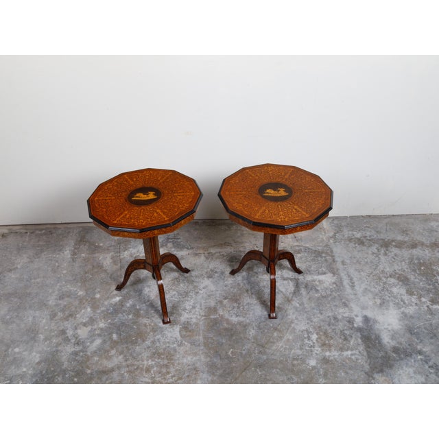 A pair of Italian Sorrento tilt top tables from the 19th century, with marquetry Mythological scene and pedestal bases....