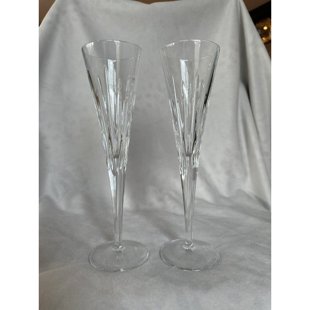 Part of the Soho Collection, this richly modern, mouth blown crystal flute set has a shimmering pattern of vertical lines...