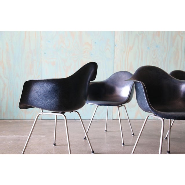 A set of 4 1960s Charles and Ray Eames for Herman miller Navy Blue shell armchairs. These are earlier examples with a...