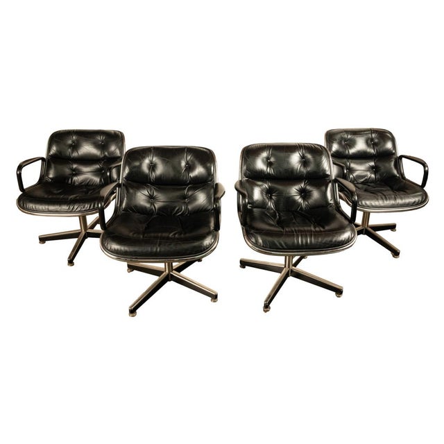 An authentic set of four Mid Century Modern Charles Pollock black leather Executive Arm Chairs, for Knoll International,...